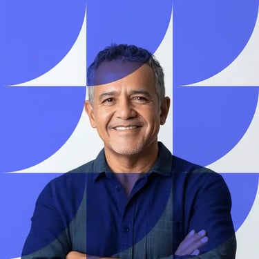 Smiling man in a navy shirt against a purple background with geometric overlay.